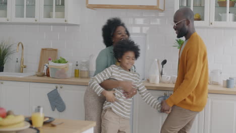 happy family dancing in the kitchen