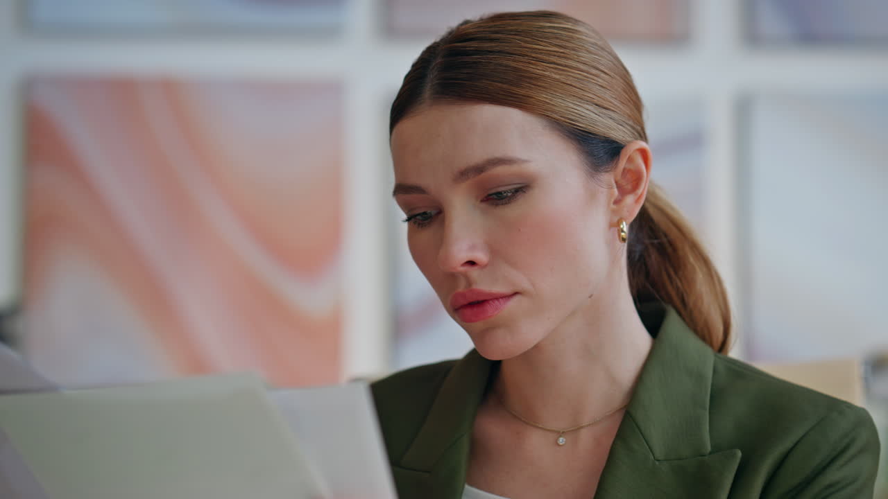 Involved boss reading documents sitting workplace in office interior closeup