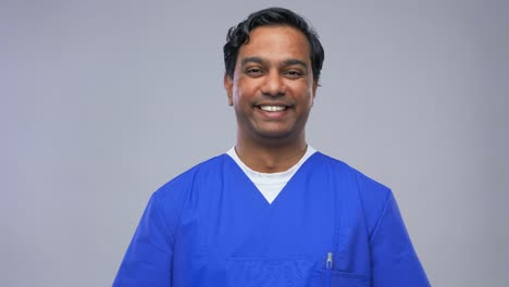 Indian-Doctor-or-Male-Nurse-in-Blue-Uniform.healthcare,-profession-and-medicine-concept-indian-doctor-or-male-nurse-in-blue-uniform-over-grey-background