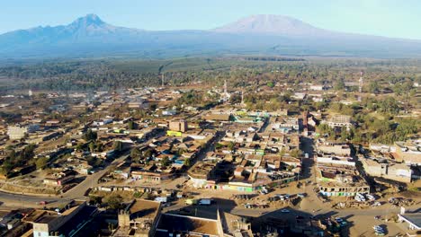 sunrise- kenya landscape with a village, kilimanjaro and amboseli national park - tracking, drone aerial view