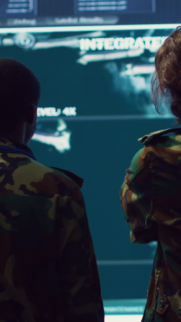 Military Soldiers in Camouflage Uniforms Analyzing Data on Large Screen