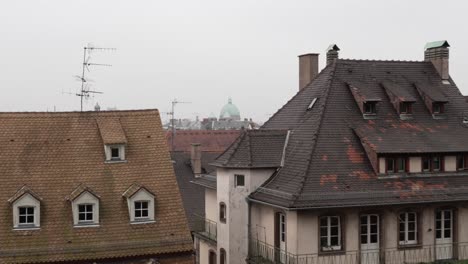 view at the rooftops of strasbourg on a misty and atmospheric day, a fusion of both german and french architectural styles creates a captivating panorama