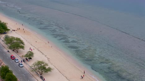 Families-and-friends-at-a-beautiful-white-sandy-beach-with-turquoise-water-ocean-on-a-public-holiday-in-capital-Dili,-Timor-Leste,-Southeast-Asia