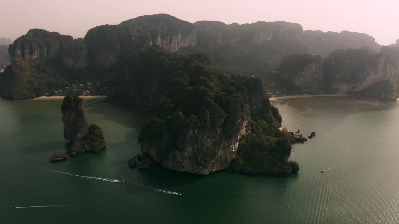 Hazy morning over Krabi, Thailand. Aerial drone shot captures dramatic limestone cliffs in a soft cinematic grade. Ideal for travel, nature, and tourism promotions.