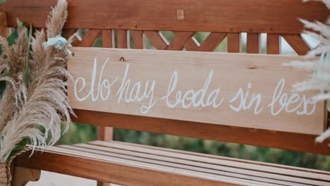 wedding bench with calligraphy and pampas