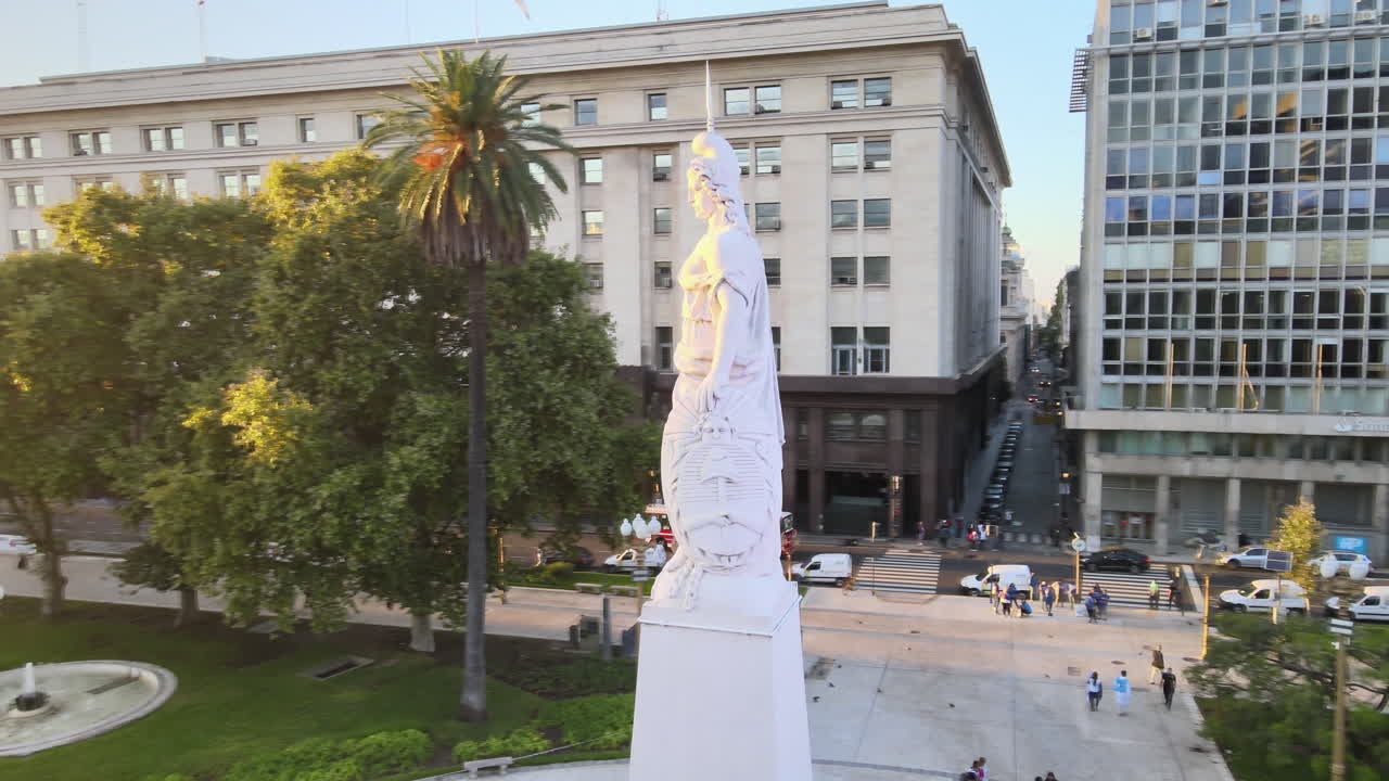 Aerial Drone Scene circling around May Pyramid, Plaza de Mayo, Casa Rosada, Buenos Aires, Argentina. Calm and warm morning sun backlight of Historic building, Flare, reflections. Furnarius Rufus.