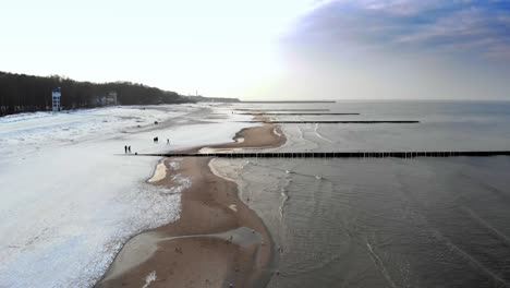 aerial shot of sandy beach in ustka in winter