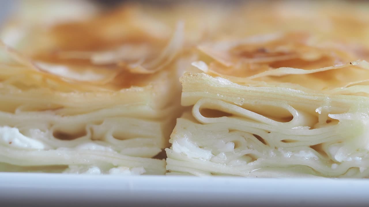 Close-up of Golden Brown Flaky Pastry with Cheese Filling