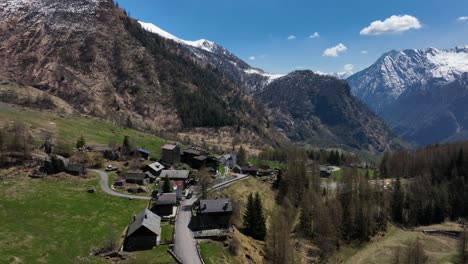 picturesque italian alp village in scenic valley surrounded by pointed mountains