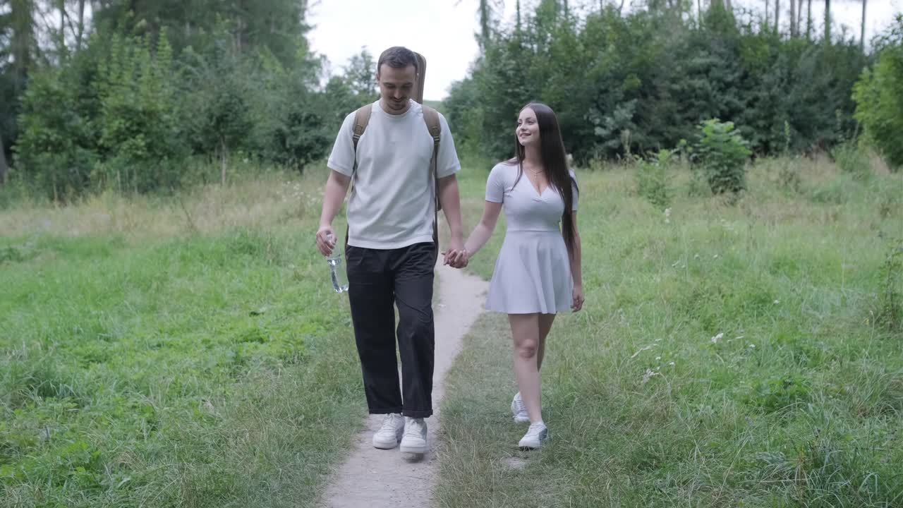 Couple Walking Hand-in-Hand on Forest Path