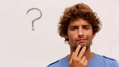 confused student standing in front of whiteboard with question mark