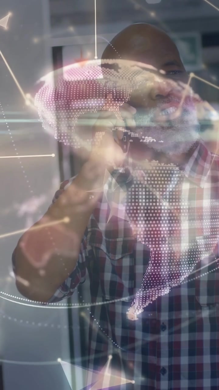 Vertical video: Office pro holding phone and gesturing, overlaying AR globe and net lines for tech