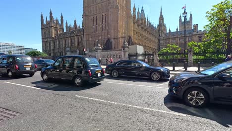 vehicles passing by big ben in london