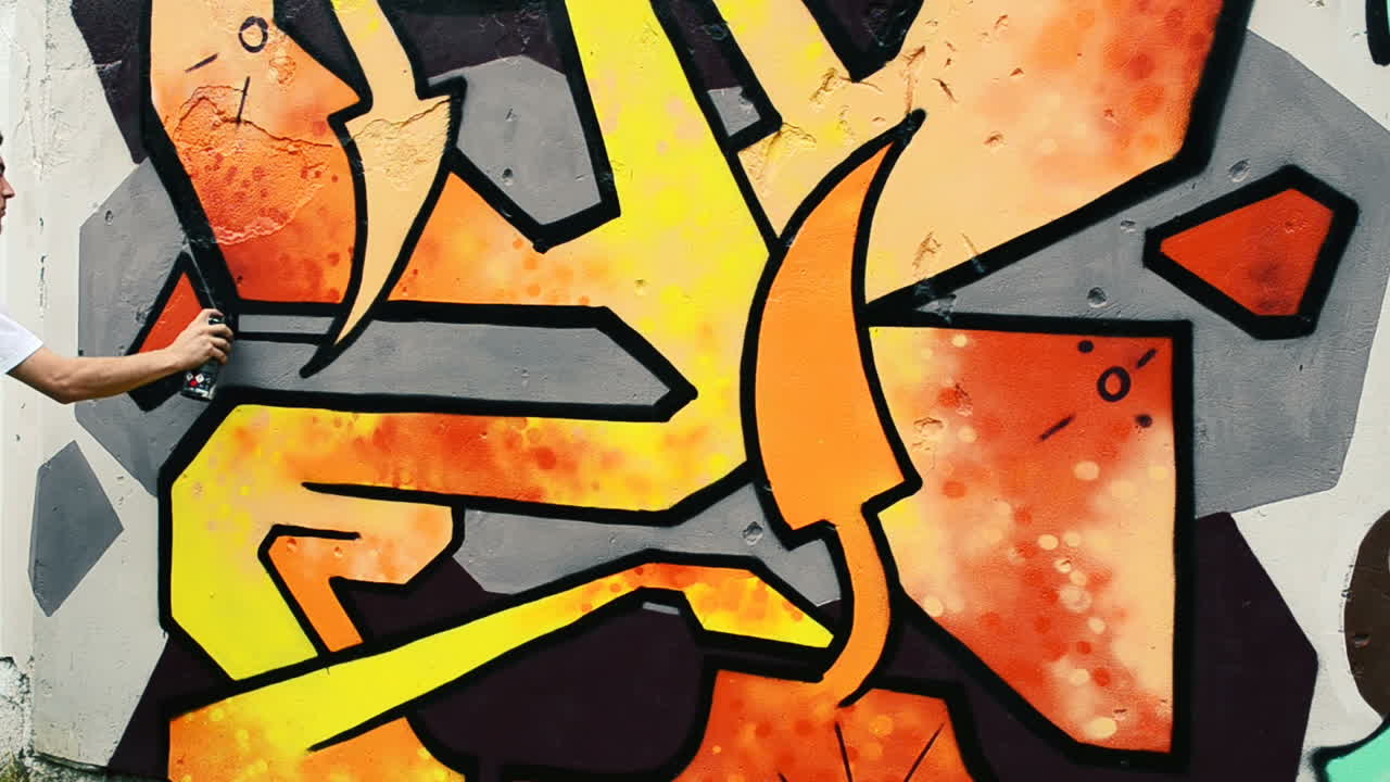 L'artista realizza graffiti su una recinzione. Disegno astratto