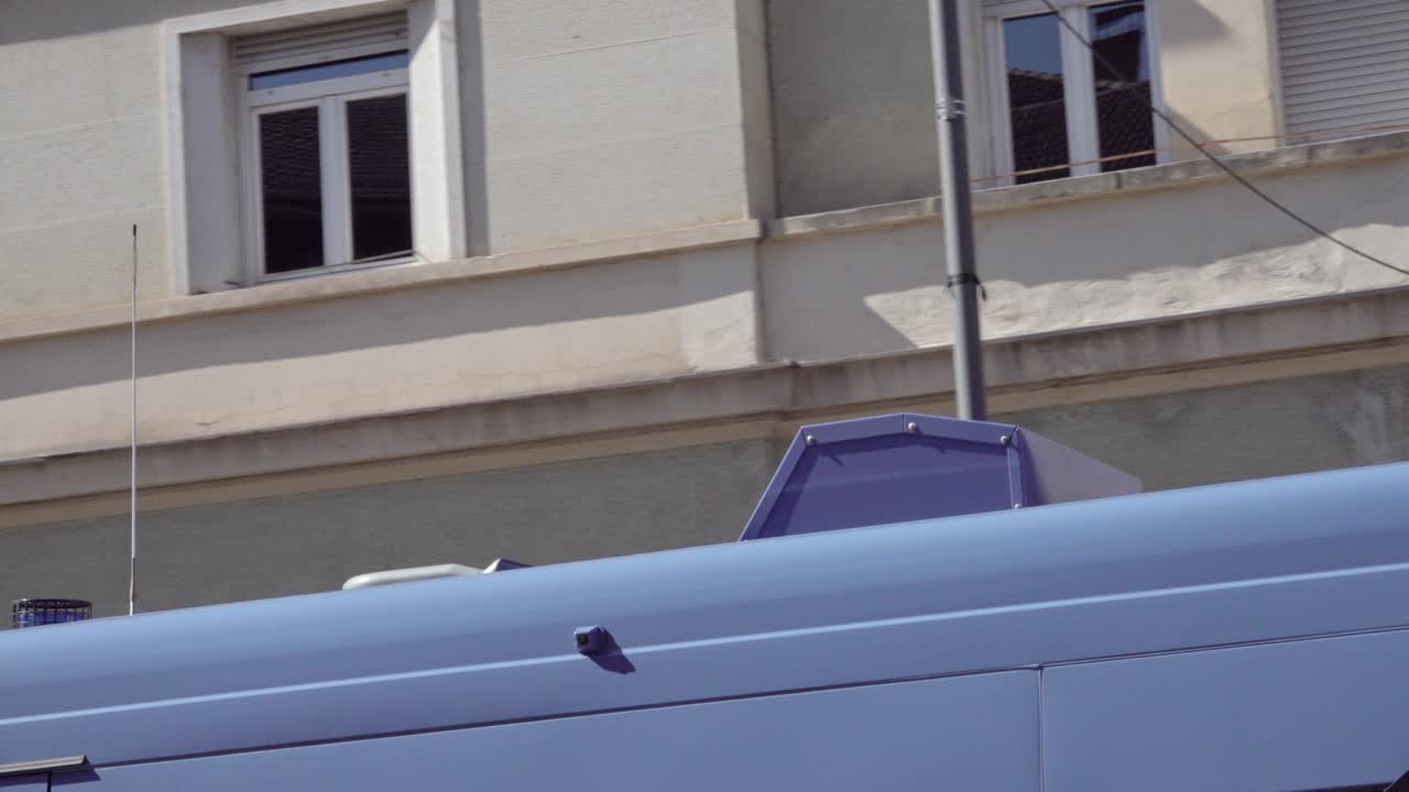 Zooming out on switched on and blinking blue lights on an on duty police car