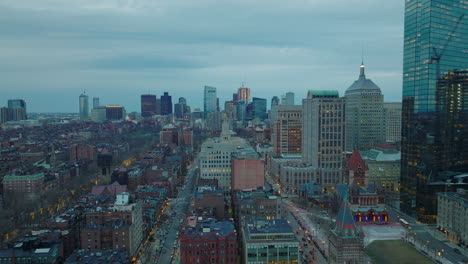 Fly-above-residential-buildings-in-Back-Bay-Borough.-Cityscape-with-modern-high-rise-buildings-in-distance.-Twilight-in-large-city.-Boston,-USA