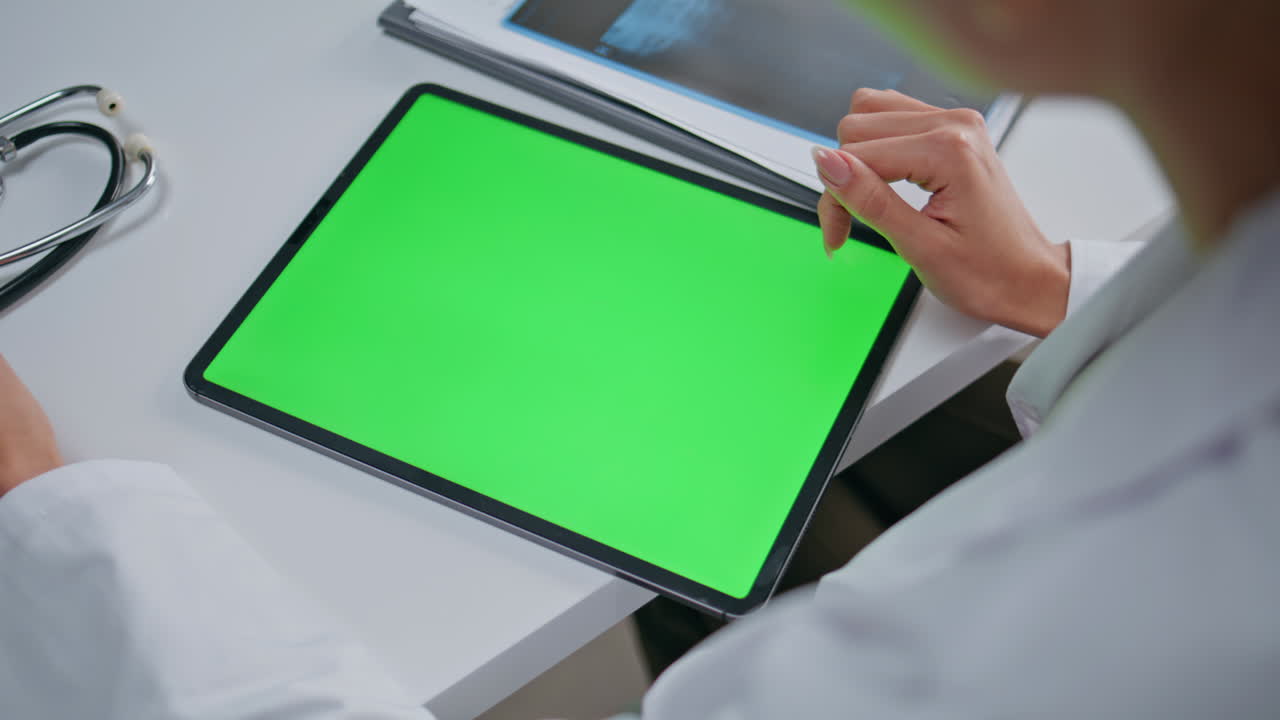 Medic hand pointing chroma key tablet in clinic closeup. Unknown woman doctor