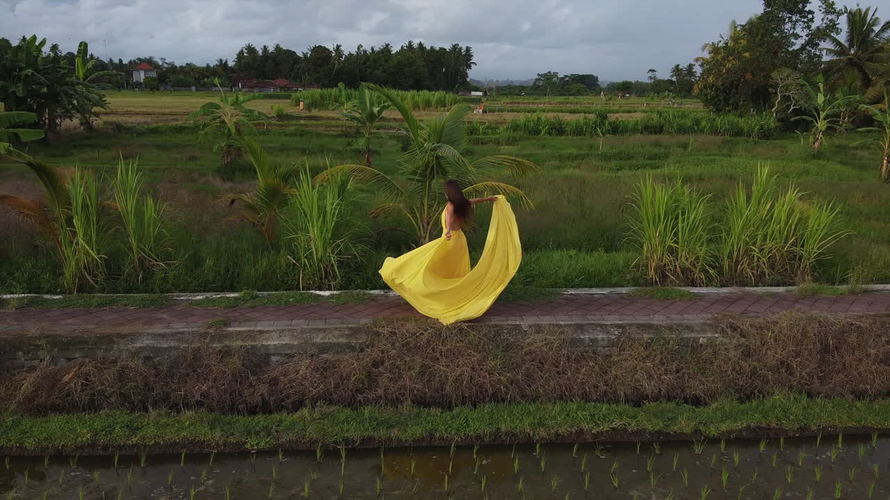 Woman in Yellow Dress in a Rice Paddy Field