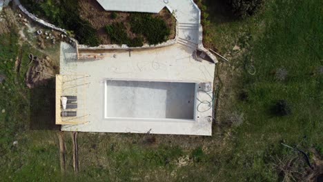 Gorgeous-aerial-view-flight-bird's-eye-view-drone-footage-of-a-empty-swimming-pool-and-a-luxury-villa-at-canyon-dream-Beach-Malibu-Corfu-Greece