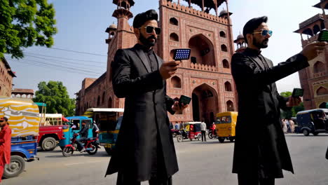 men in black outfits on a city street