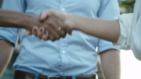 close up footage of three colleagues shaking hands