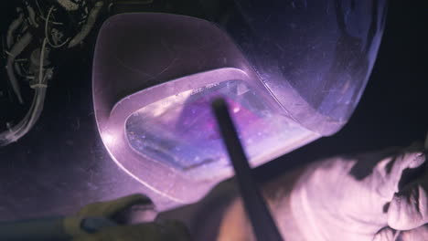 welder wearing protective face mask working in factory