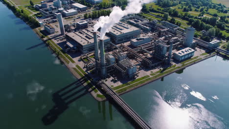 aerial view of an industrial complex by a waterway