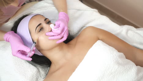 hands of cosmetologist making injection in face. rejuvenating facial injections. aesthetic cosmetology.