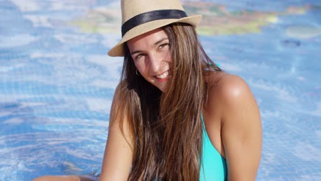 smiling long haired beauty wearing bikini and hat