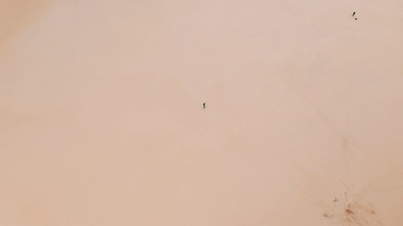 모래 언덕을 걷는 사람의 높은 공중 하향식 전망