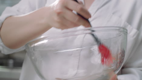 brushing a bowl with olive oil in preparation to put pizza dough inside
