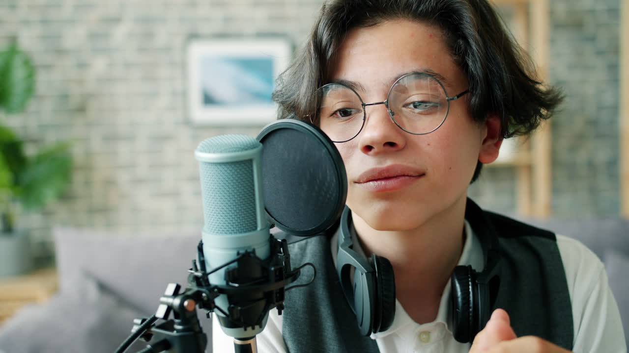 Teenager Singing Into a Microphone