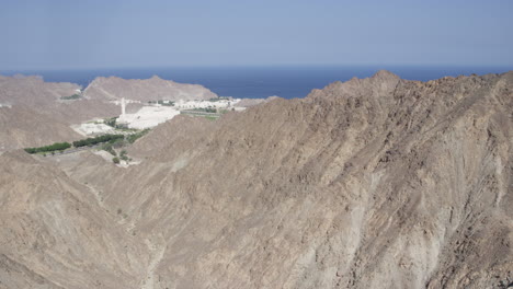 port sultan qaboos and the al hajar mountains in muscat, oman, wide shot