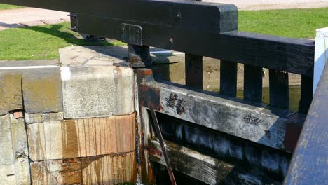 water flowing into lock gates to fill the lock see levels of water on both side of the lockgates