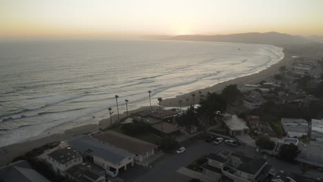 aerial view of a coastal sunset with beach and houses