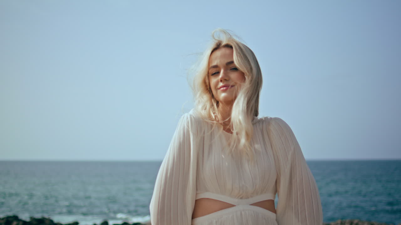 Romantic traveler posing beach enjoying summer close up. Woman standing seashore