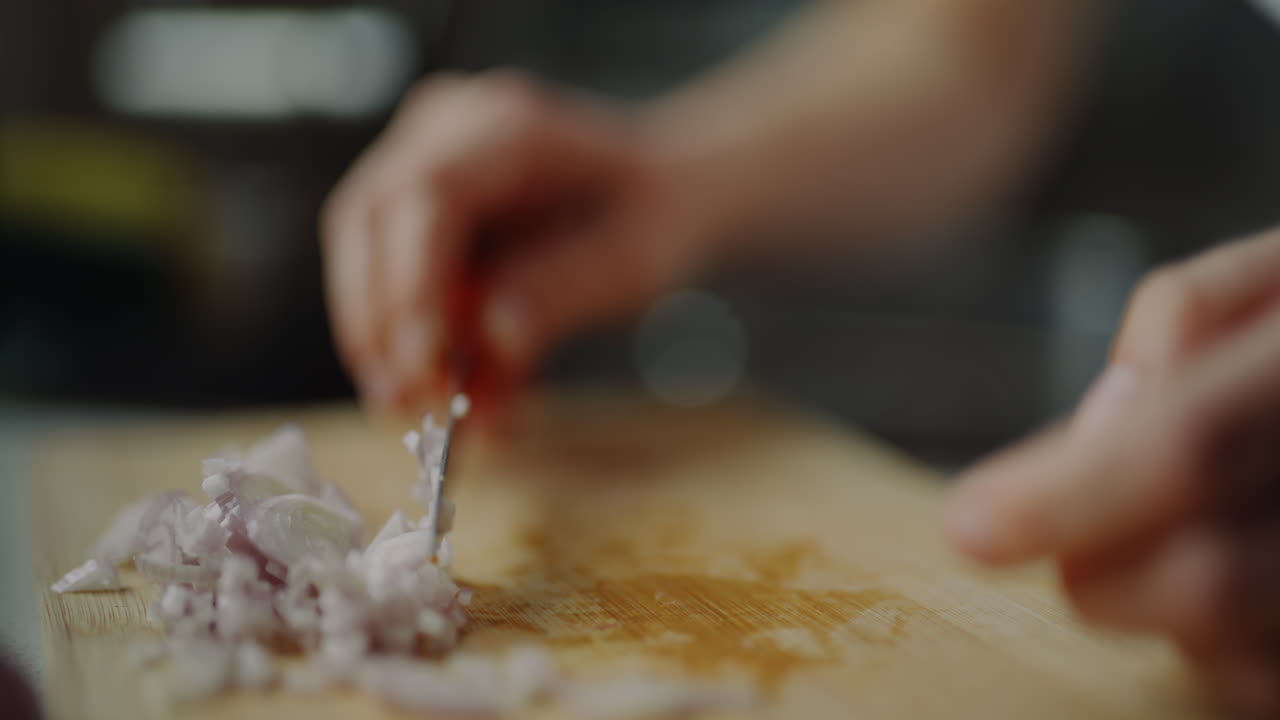 Close-Up Of Finely Chopped Onion On Wooden Chopping Board