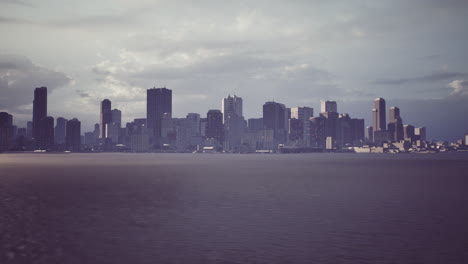 urban skyline under cloudy sky with calm water reflecting the city view