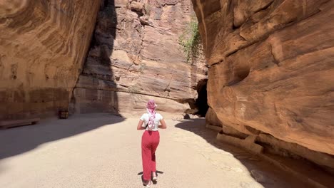 tall women walking in petra in wadi musa, close to the treasury of jordan with no other people around 4k