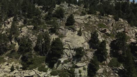 Drone-advancing-through-the-lake-and-then-ascending-to-get-to-the-top-of-the-mountain-in-La-Cerdanya,-Catalunya