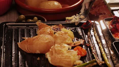 french swiss or spanish restaurant with traditional tapas food, spanish cuisine, delicious tapas and cheese plate, bruschetta with cheese, olives dry tomatoes and tasty sandwich bar appetizer, buffet