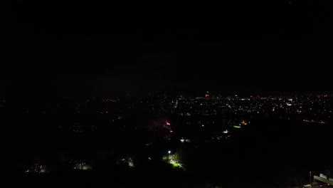 Aerial-shot-of-large-vibrant-geometrical-fireworks-exploding-at-guy-fawkes-night