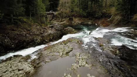 dramatic flight over the top of dougan falls, pan down to reveal churning water