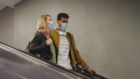 caucasian couple on the go wearing a coronavirus covid19 mask