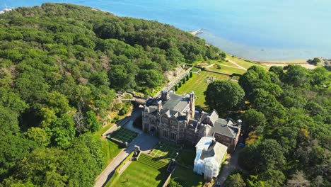 aerial view of tjoloholm castle located on a peninsula in the kungsbacka fjord in halland, sweden. drone ascend