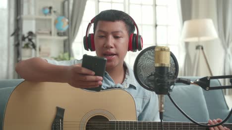 teenage boy recording music at home