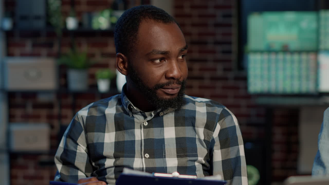 Male broker working with woman to develop stock exchange strategy