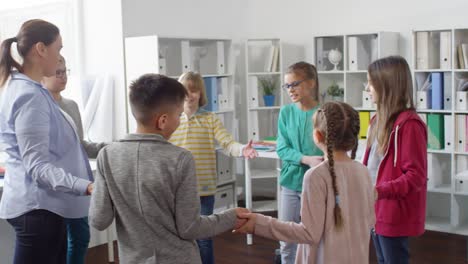 six teenagers playing passing game with teacher