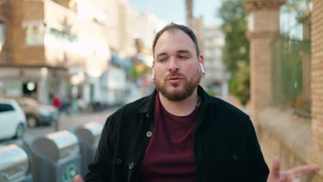 young plus size man listening to music and dancing at street