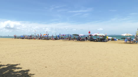 fishermen are sorting out their fishing gear such as nets, ice boxes, buoys, as they prepare to go fishing while some are preparing some dishes with their fresh catch in pattaya beach, thailand